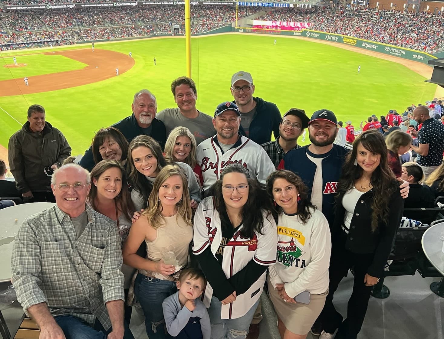 Omega Bank Card Services team group photo at Truist Park during an Atlanta Braves game